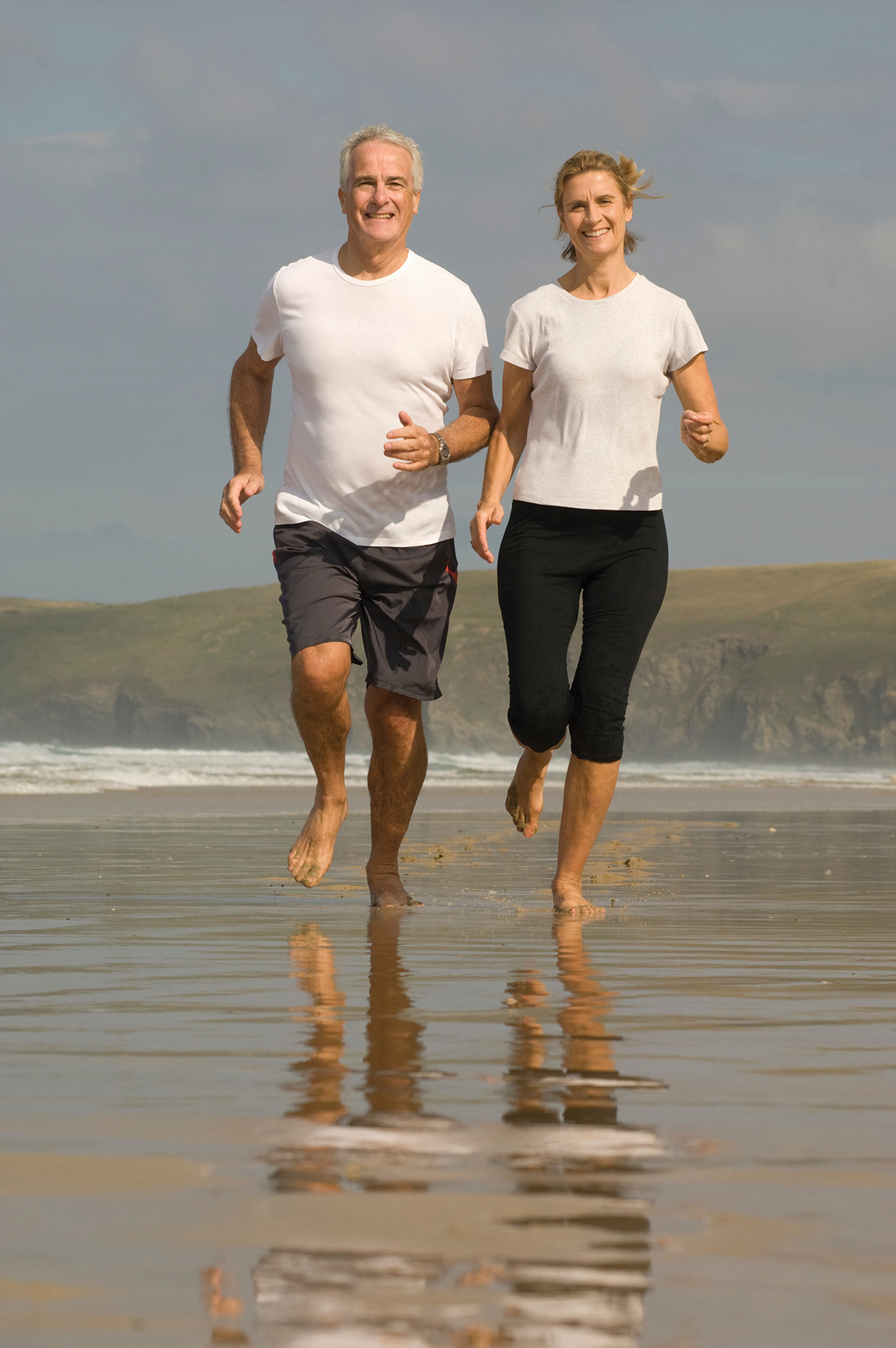 couple-running-on-a-beach-2022-03-08-00-07-03-utc Image of a couple running on the beach